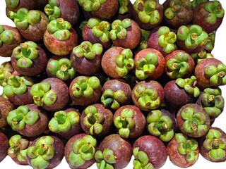 Mangosteen is Thailand’s national fruit, known as the Queen of Fruits. It has a sweet and slightly sour taste. Fresh tropical fruit on white background.