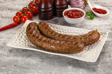 Grilled beef sausages with sauce