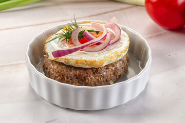 Beefsteak chop with roasted egg