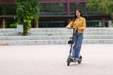 Young woman riding electric scooter in urban environment