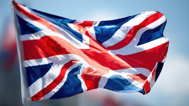 British flag waving outdoors with bright sky and vibrant colors in motion.