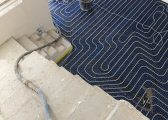 Floor heating installation in a new building, plastic pipes and pipelines. Modern heating system
