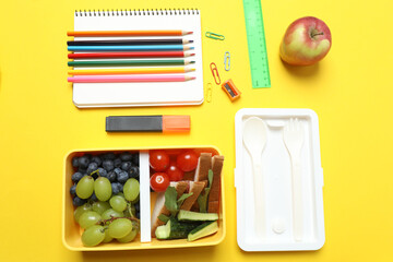 healthy lunch box with school backpack, apple and stationery on color background