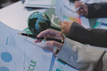 Asian woman lead young group of multiethnic businesspeople in team meeting, using laptop computer for ESG topic presentation on monitor. Sustainable business practice, people work at home concept