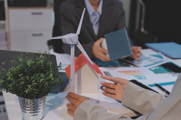 Asian woman lead young group of multiethnic businesspeople in team meeting, using laptop computer for ESG topic presentation on monitor. Sustainable business practice, people work at home concept