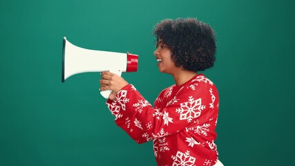Christmas, marketing and megaphone with woman in studio for festive announcement or retail promotion. Bullhorn, sale and shouting with African person isolated on green background for publicity - Powered by Adobe