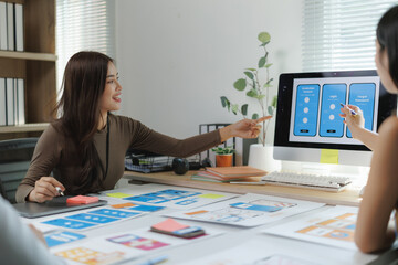 Web designers working on user interface and user experience of mobile application