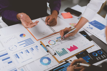Business people analyzing financial charts and graphs at meeting