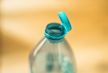 Plastic cap connected to a plastic bottle. Bottle design with the cap attached to the bottle for...