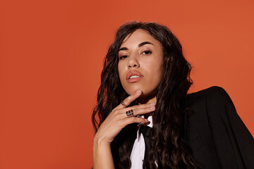 Wistful gaze of a scholar contemplates ideas against an orange backdrop in a studio