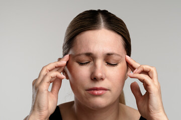 Woman Experiencing Stress and Headache Holding Her Head