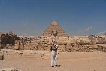 Tourist visiting the great pyramid of giza and the sphinx in egypt