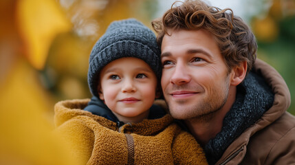 Obraz premium Happy father and son bonding in autumn park