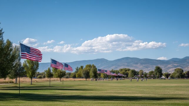 Wide panoramic view of a patriotic outdoor scene with American flags and mountain backdrop. - Powered by Adobe