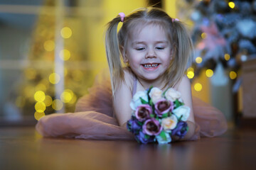 A small girl child with a bouquet of flowers. A gift for girls on female holiday with flowers on...