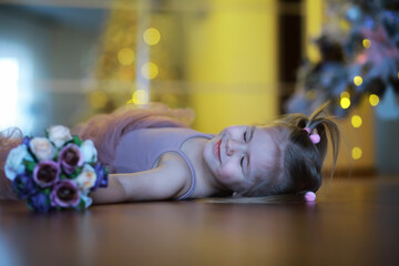 A small girl child with a bouquet of flowers. A gift for girls on female holiday with flowers on...