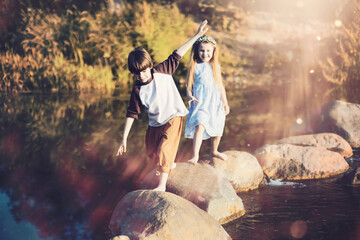 Children walk in the park in autumn. Child outdoors on a sunny summer morning in the park.