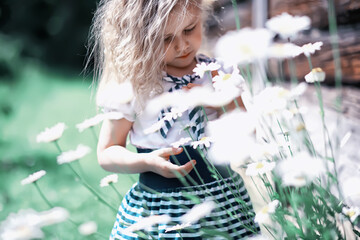Cute little girl  on the meadow in spring day