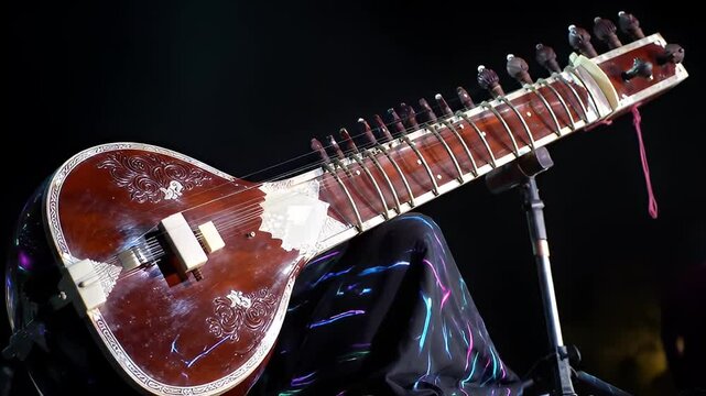 Angled view of an ornate sitar on a patterned cloth with a dark background