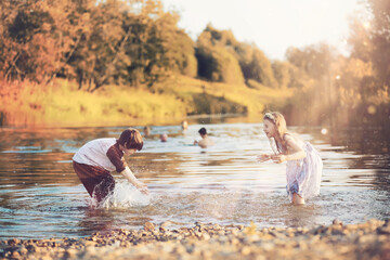 Children walk in the park in autumn. Child outdoors on a sunny summer morning in the park.