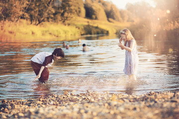 Children walk in the park in autumn. Child outdoors on a sunny summer morning in the park.