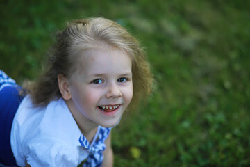 Happy little girl with flowers in the field