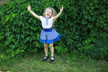 Happy little girl with flowers in the field