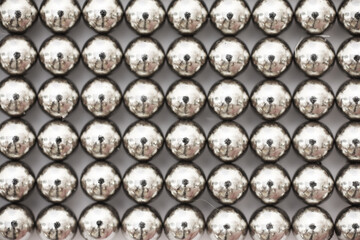 magnetic ball bearing tiling in perfect hexagonal grid. Metal balls close up. Balls of neodymium...
