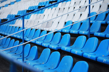 Plastic chairs in the stands of a sports stadium. Cheer on the stands of the stadium.
