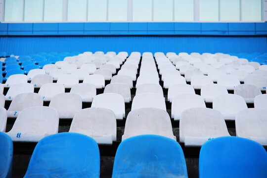 Plastic chairs in the stands of a sports stadium. Cheer on the stands of the stadium.