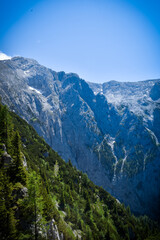 A breathtaking point of view reveals a steep mountain face rising sharply from the valley below....