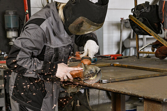 Manufacturing industry plant factory welding turner milling machine operator welder girl woman sparks grinder - Powered by Adobe
