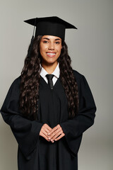 Young student exudes joy in graduation outfit with an elegant and confident smile