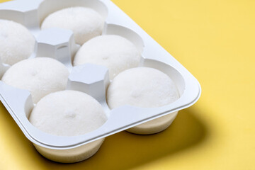 Japanese Coconut ice cream mochi on yellow background