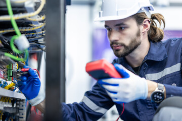 Electrical engineer testing artificial intelligence robot arm at high technology research...