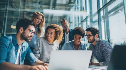 Business team collaborating and discussing project ideas using a laptop in modern office.