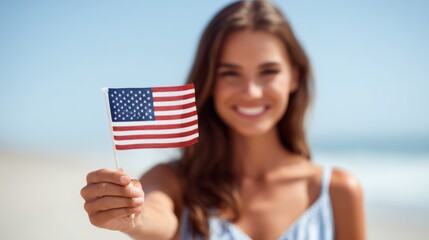 Happy young woman smiling and holding American flag outdoors with blue sky.