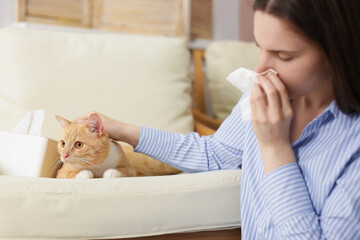 Woman suffering from allergy with her cat at home