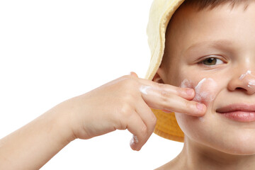 Little boy applying sun protection cream onto his skin on white background, closeup