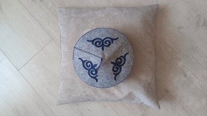 A skullcap lying on a soft pillow, close-up. Traditional headdress on a cozy background.