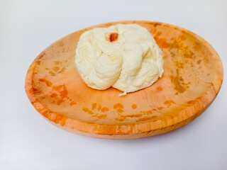 Bakpao or Steamed Chinese Bun served on a wooden plate. Isolated on white background.