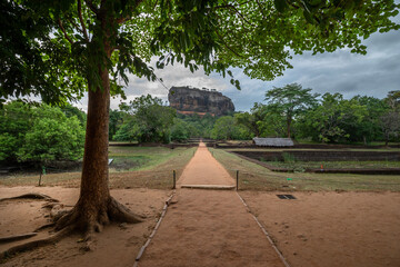SIGIRIYA, SRI LANKA - JULY 15, 2024 : A view from the Royal Gardens looking towards Sigiriya Rock Fortress in central Sri Lanka.