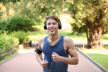 Sporty man with headphones running in park