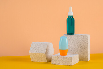 Cosmetic product in tube, bottle, lotion or serum with stylish props on cream background. 
