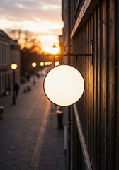 Backlit round blank shop sign mockup on rustic wood wall, aerial view sunset, cozy town street, branding, storefront signage, hospitality, tourism promotion, local business identity, evening city mood
