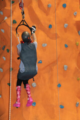 A Person Practicing Climbing on an Indoor Artificial Wall.