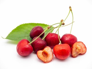 Fresh red cherries with green leaves.