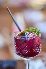 a glass of a cocktail with selective focus and blurred background