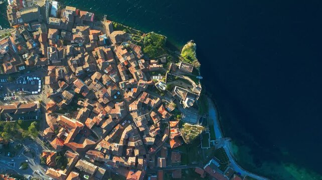 A stunning aerial shot of Malcesine&rsquo;s medieval old town&mdash;narrow alleys, terracotta roofs, and the deep blue of Lake Garda blending into a perfect composition.