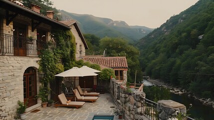 Idyllic mountain retreat with stone villa overlooking a tranquil river and lush greenery